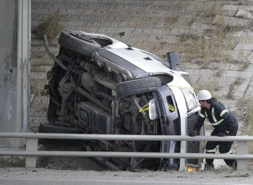 A tow truck operator at the scene of a over turned pickup truck Tuesday morning that was travelling on the Perimeter Hwy. under the Roblin Ave. over pass. No reports of injuries.  WAYNE GLOWACKI / WINNIPEG FREE PRESS) Nov.4 2014