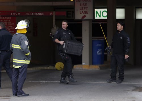 Wpg Police prepare to remove device that looked like a pipe bomb from Delta Hotel underground parking area after a bomb scare caused evacuation of the Hotel and closes St. Mary's Ave for most of the morning .NOV. 4 2014 / KEN GIGLIOTTI / WINNIPEG FREE PRESS