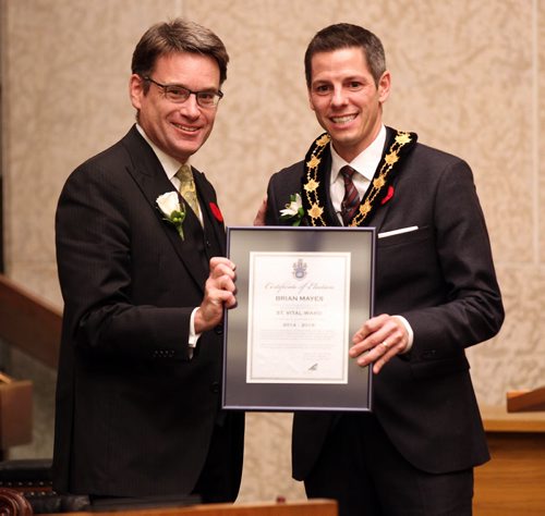 Mayor Brian Bowman presents counselman Brian Mayes with his certificate of office Tuesday evening. See Mary Agnes Welch story.  November 4, 2014 - (Phil Hossack / Winnipeg Free Press)