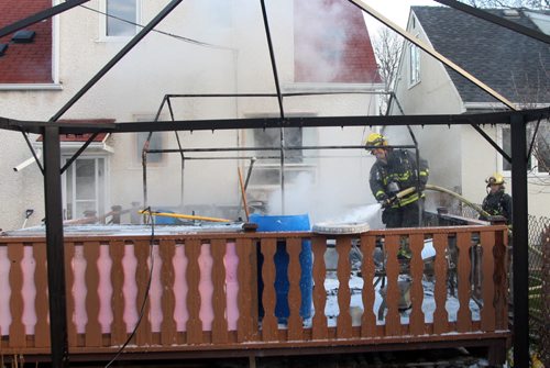 A deck fire sent Fire crews scrambling Wednesday morning as a large plume of heavy black smoke poured out of the rear of a home at Bannatyne Ave and Cecil St  - Fire crews quickly extinguished the blaze with little extension to the home- Breaking News  Nov 05, 2014   (JOE BRYKSA / WINNIPEG FREE PRESS)