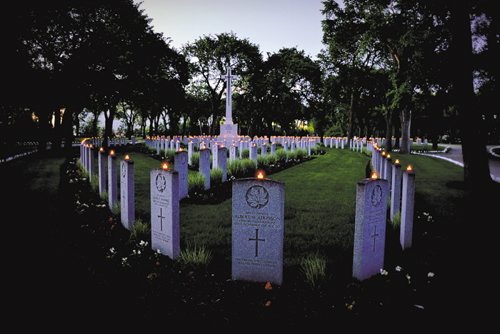 Canstar Community News LG2012-3170Date: 03 June 2012Location: Brookside Cemetery, Winnipeg, MBPhoto By: MCpl Gregory Rutledge, 38 CBG PhotojournalistWinnipeg, MB - The candlelit headstones of Canadian soldiers killed in World War One encircle the Cross of Sacrifice at Brookside Cemetery.To mark the Queen's Diamond Jubilee, Winnipeg's Brookside Cemetery hosted a Candlelight Service of Remembrance in commemoration of the 12,000 Canadian Forces veterans buried in its Military Field of Honour. Youths from the Army and Sea cadet programs placed LED candles on the headstones of each soldier buried in Canada's oldest and largest military internment site, which glowed through the warm summer night in spectacular fashion. The Winnipeg service was inspired by the citizens of The Netherlands, who light candles in memoriam for Canadian soldiers that died liberating their communities during The Second World War. Many local, provincial, federal, and military dignitaries attended the service alongside members of the public and veterans' families.¬© 2012, DND/MDN, Canada.
