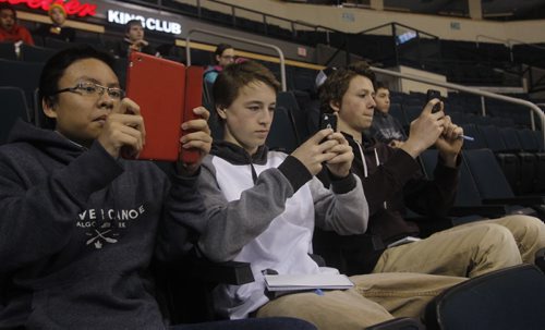 Grade 9 students, offspring of Winnipeg Free Press employees involved in Take Our Kids to Work day attend the Winnipeg Jets practice in the MTS Centre Wednesday. From left is Joe Nguyen, Jon Sneesby and Josh Samyn take pictures and video at practice.   WAYNE GLOWACKI / WINNIPEG FREE PRESS) Nov.5 2014
