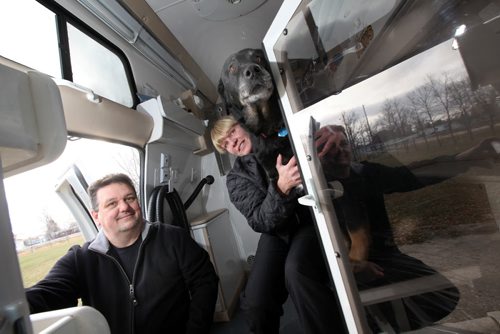 Rob and Brenda MacFarlane pose inside their mobile dog grooming clinic Wednesday with one of their own pooches.The custom designed van parks in your driveway while the pair trim up your pet. They specialize in nervous or hard to work with dogs. See Doug Spiers story. November 5, 2014 - (Phil Hossack / Winnipeg Free Press)