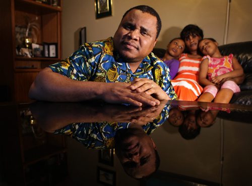 Alie Nasralla wants to visit his extended family over Christmas in Sierra  Leone but is concerned about quarantine requirements on his return home.  He sits with his family, Katherine (wife), Alrina (older girl) and Linda (youngest) in their home in Fort Rouge. See Carol Sanders story.  Nov 5,  2014 Ruth Bonneville / Winnipeg Free Press