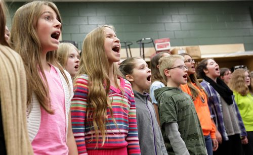Members of the  Winnipeg Youth Chorus give it their all as they rehearse for the last time at Miles Macdonell Collegiate before heading off to New York City to perform at Alice Tully Hall in Lincoln Center during the US's Veteran's Day weekend to sing a Holocaust Oratorio  written by Winnipeg composer Zane Zalis.  Standup photo Nov 5,  2014 Ruth Bonneville / Winnipeg Free Press