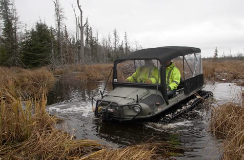 Whiteshell Provincial Park, Province of Manitoba employees Stephen Bodner, left, and Sean Nedohin show Argo 750 Avenger vehicle in the Whiteshell on Thursday. The vehicles have are curious looking amphibious things on caterpillar tracks, with 8 wheels, good for crawling across rock terrain and through deep swamps  . The Provincial crews use the vehicles to crawl through rough terrain preparing winter snowmobile trails- See Bill Redekop story Nov 06, 2014   (JOE BRYKSA / WINNIPEG FREE PRESS)