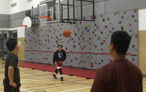 In centre,  Sean Cunanan and his friends play basketball in the community gym that includes a climbing wall after a dedication ceremony was held Friday to officially open the University of Winnipeg's UNITED Health & RecPlex.  The $40 million facility is the most comprehensive ever built in Winnipegs inner city, designed to meet the needs of three main groups: neighbourhood youth and residents; amateur sports organizations requiring rental space; and UWinnipeg students, Wesmen. It includes a large multi-use artificial turf, 4 lane rubberized sprint track and jump pit, Thomas Sill Community Multi-purpose room and a  retractable batting cage. See release WAYNE GLOWACKI / WINNIPEG FREE PRESS) Nov.7 2014