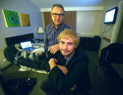 20-year-old Austin Saunders and Pat Werestiuk, the 60-year-old who found him pose in his temproary quarters a room at the Airport Motor Inn on Ellice ave. See Sinclair Story. November 7, 2014 - (Phil Hossack / Winnipeg Free Press)