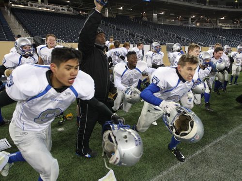 The Oak Park Raiders go nuts after defeating the St Paul Crusaders for the Manitoba High School Football Championship at the Investors Group Field Friday night-See Ed Tait story Nov 07, 2014   (JOE BRYKSA / WINNIPEG FREE PRESS)