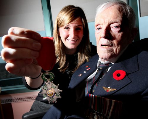 Doug Brown poses with his grand-daughter Carrie holding his medal awarded by France. See story re: Lt. Colonel (Retired) Douglas Edwin Brown, in January 2013 upon celebrating his 90th birthday and the attached article that you wrote and featured in the Winnipeg Free Press on his RCMP, WWII D-Day and POW, business and military experiences.  In recognition of his service to France, he has been appointed a Knight of the National Order of the Legion of Honour by the Government of the Republic of France. Daughter Carrie nominated her grandfather for the award. This is his medal. See Kevin Rollason story. November 10, 2014 - (Phil Hossack / Winnipeg Free Press)