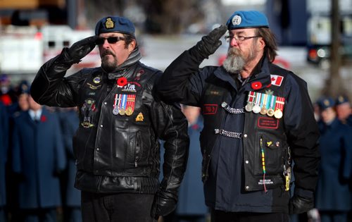A pair of Peace Keepers salute after laying a wreath to UN and Nato Veterans at the Bruce Park Cenotaph Tuesday morning for the annual Remembrance Day service. See story. November 11, 2014 - (Phil Hossack / Winnipeg Free Press)