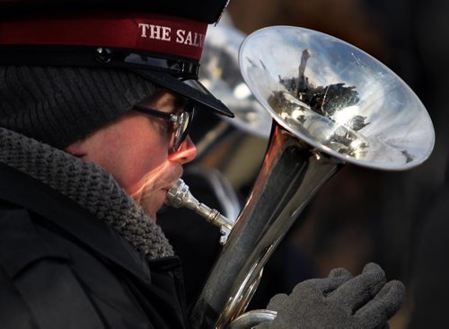 The Bruce Park Cenotaph is reflected in the horn of a Salvation Army musician as hundreds gathered Tuesday morning for the annual Remembrance Day service. See story. November 11, 2014 - (Phil Hossack / Winnipeg Free Press)