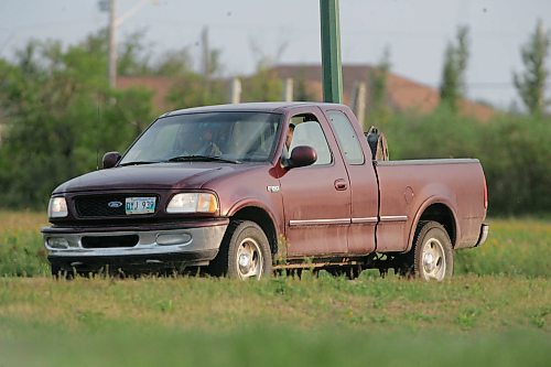 BORIS MINKEVICH / WINNIPEG FREE PRESS  070819 Possible armed standoff scene on McGregor Farm Road just north of Bricker Ave. in East St. Paul. RCMP used their SWAT team and robot in the operation. This truck drove up and the owner picked up the dog that wondered on scene.