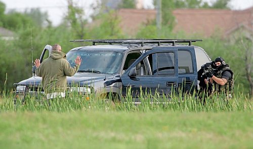 BORIS MINKEVICH / WINNIPEG FREE PRESS  070819 Possible armed standoff scene on McGregor Farm Road just north of Bricker Ave. in East St. Paul. RCMP used their SWAT team and robot in the operation. A dog wondered onto the property and was later fetched by it's owner. The owner of the dog was met by SWAT members at gunpoint and then released.