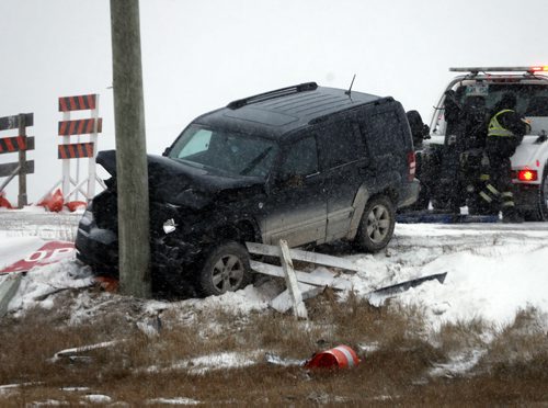 ICY ROAD  CONDITIONS outside and inside the city . In pic 2 vehicle mvc with a SUV into a pole , in the bridge construction area on Hwy 1 east of Hwy 12 . A pickup truck went off the road deploying it's air bag a second SUV hit a pole . Unknown how many injuries . Contact Steinbach RCMP NOV. 12 2014 / KEN GIGLIOTTI / WINNIPEG FREE PRESS