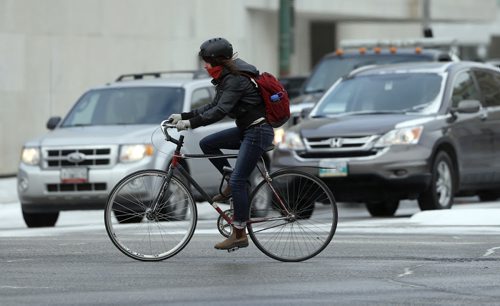 STDUP .A cyclist trying to stay warm crosses Memorial Blvd on a icy cool day . NOV. 12 2014 / KEN GIGLIOTTI / WINNIPEG FREE PRESS