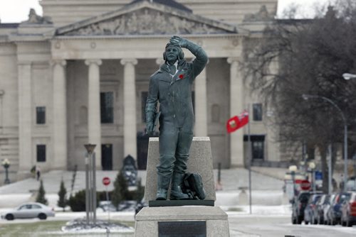For File . Airman in Training bronze statue at Memorial Park after Remembrance Day ceremonies with poppy . Someone placed poppies on all the statues in the park .For many years the Airman in Training statue had roses placed at it's base . NOV. 12 2014 / KEN GIGLIOTTI / WINNIPEG FREE PRESS