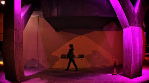A pedestrian walks along Hargrave Street by the Delta Hotel where coloured lights light the way Wednesday night.  141112 November 12, 2014 Mike Deal / Winnipeg Free Press