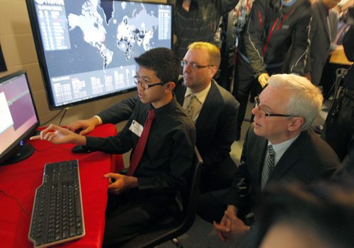 Education and Advanced Learning Minister Peter Bjornson and Premier Greg Selinger watch Sisler student Deven San Miguel demonstrate cyber attack monitoring in the lab at the school. Expansion of Sisler's cyber security academy, giving more students access to some of the most advanced learning opportunities in Canada. BORIS MINKEVICH / WINNIPEG FREE PRESS November 13, 2014