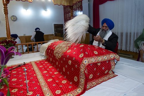 A member of the Sikh congregation at the Sikh Society of Manitoba on Mollard Road acting as the care taker or Granthi of the Guru Granth Sahib waves a whisk over Holy Scriptures as a sign of respect. 141113 - Thursday, November 13, 2014 -  (MIKE DEAL / WINNIPEG FREE PRESS)