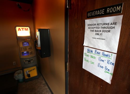 THe entrance to the the beverage room at the Whitemouth Hotel features winter hours and an ATM. The 150 yr old hotel strugggles according to owner....November 13, 2014 - (Phil Hossack / Winnipeg Free Press)