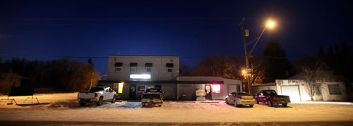 The Fraserwood Tourist Hotel and Beverage Room glows along the village main street in the Interlake north of Winnipeg. November 13, 2014 - (Phil Hossack / Winnipeg Free Press)