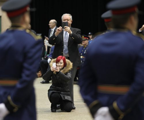 "CLOSE INSPECTION" Friends and family close in on the parade square Friday to photograph Winnipeg's newest police graduates! Nineteen members of class #156 received their honors and certificates in a ceremony at the Convention Center. See release. November 14, 2014 - (Phil Hossack / Winnipeg Free Press)