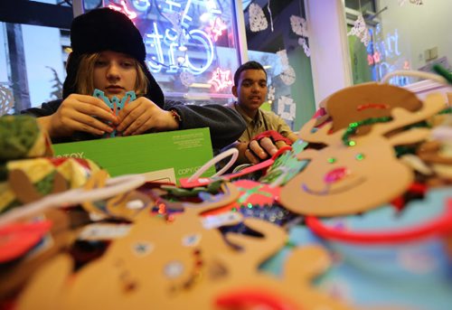 At Art City on Broadway, Anya Repko, 13, and Korrdel Christian, 15, working on Christmas decorations and gifts that will be handed out during the Santa Claus Parade on Saturday, Friday, November 14, 2014. (TREVOR HAGAN/WINNIPEG FREE PRESS)