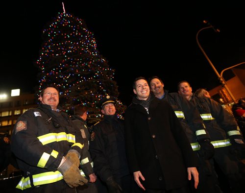 Mayor Brian Bowman speaks with firefighters and paramedics after he lit the Christmas Tree in front of City Hall, Friday, November 14, 2014. (TREVOR HAGAN/WINNIPEG FREE PRESS)
