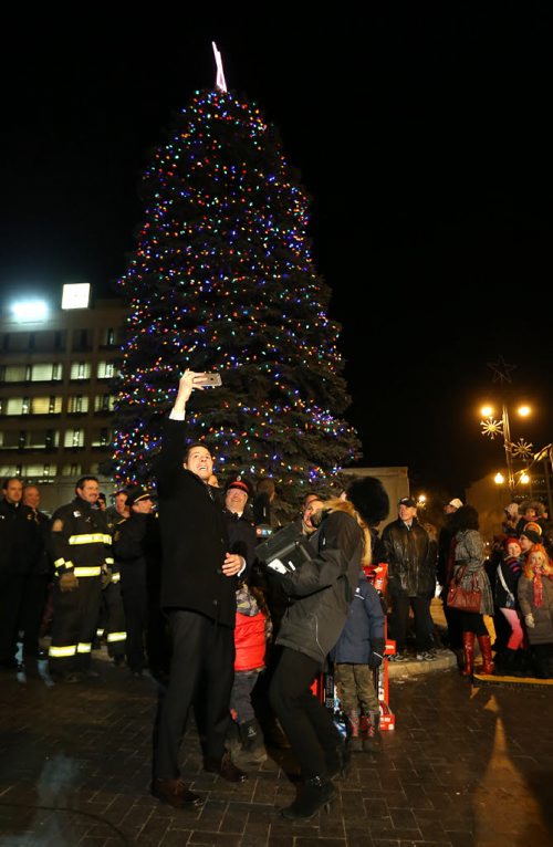 Mayor Brian Bowman, left, takes a selfie as he lights the Christmas Tree in front of City Hall, Friday, November 14, 2014. (TREVOR HAGAN/WINNIPEG FREE PRESS)