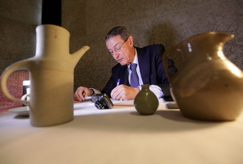 Appraiser Jack Kerr-Wilson of Bonhams a British auction house examines studio pottery Saturday during the WAG's appraisal weekend where people can bring in their favourite possession's to be appraised.  Standup photo  Nov 15,  2014 Ruth Bonneville / Winnipeg Free Press