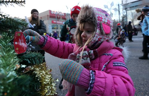 Isla Penner, 5, participating in a Christmas Tree decorating competition prior to the Santa Claus Parade, Saturday, November 15, 2014. (TREVOR HAGAN/WINNIPEG FREE PRESS)