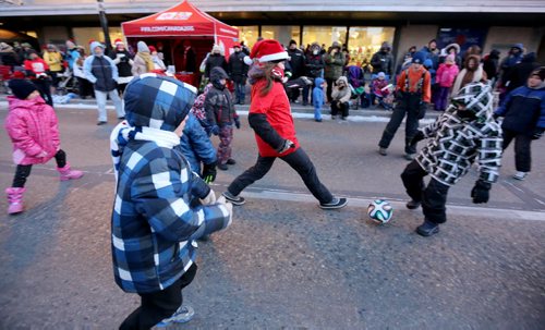 FIFA had a game of soccer in the street prior to the Santa Claus Parade, Saturday, November 15, 2014. (TREVOR HAGAN/WINNIPEG FREE PRESS)