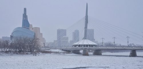 Blowing snow makes for a subdued skyline of Winnipeg's downtown Sunday morning.  141116 November 16, 2014 Mike Deal / Winnipeg Free Press