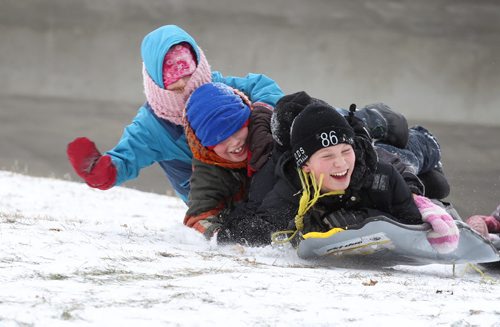 The Wilkinson family take a break Tuesday over the lunch hour from home schooling by going out sliding for the first time this winter at the "River Hill" which runs under the train tracks along Wellington Cresent.  Siblings are all smiles as they try and slide together Tuesday.  Names: Lowell - 12yrs (bottom), Quinn - 11yrs (face hidden), Scott -9yrs and Susanna -7yrs Standup photo  Nov 18,  2014 Ruth Bonneville / Winnipeg Free Press