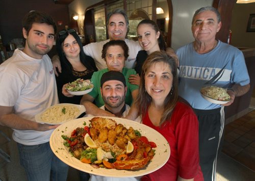 The Sorrentos family shows off their dinner for two at their location at 529 Ellice Ave in downtown Winnipeg  L to R rear- Jordy Lomonaco, Mena Perrault, Gerry Lomonaco, Carly Lomonaco,, Alfonso Lomonaco, grandmother Antonietta Lomonaco,centre, and L to R front row Franco Lomonaco and Bri Dottavio - See Marion Warhaft review Nov 18, 2014   (JOE BRYKSA / WINNIPEG FREE PRESS)