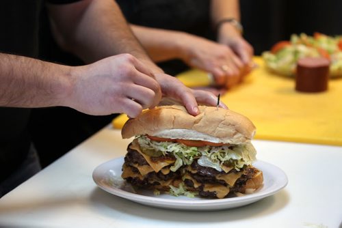 Sunday This City column on Red Top Drive Inn - 219 St. Mary's Rd. with owners Vicky Scouras and her son Peter Scouras  they will be  celebrating its 55th b-day next year. Peter Scouras  puts the finishing touches on the monster burger.  Nov 18,  2014 Ruth Bonneville / Winnipeg Free Press