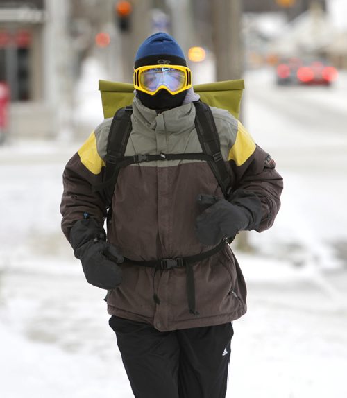Daniel Gravenor on the sidewalk along St. Matthews Ave. Wednesday morning on his daily run to work. Wayne Glowacki / Winnipeg Free Press Nov. 19  2014