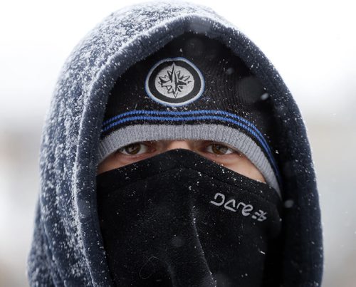 Stdup , "There is no Bad Weather , Just bad clothing " says David Brownsey-Joyce  with a laugh , he's originally from England , spending his second winter in Winnipeg , seen walking in Osborne Village during a snow squall .  NOV. 19 2014 / KEN GIGLIOTTI / WINNIPEG FREE PRESS