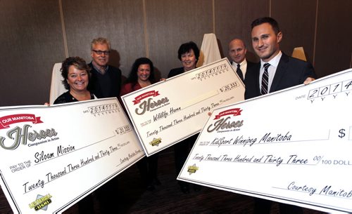 Big cheques from Our Manitoba Heroes committee were handed out Wednesday to three deserving organizations. Gathered for the photo from left, Judy Richichi representing the Siloam Mission, Paul Bennett, Committee Chair and Brenda Bourns both with Our Manitoba Heroes, Judy Robertson, representing the Wildlife Haven Rehabilitation Organization, Jeff McWhinney,  Our Manitoba Heroes committee member and Matt Erhard representing KidSport Winnipeg. The three local charities each received $20,333.00 from the proceeds from the Our Manitoba Heroes gala event that was held September 27th.  Wayne Glowacki / Winnipeg Free Press Nov. 19  2014