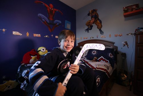 Eight year old Connor McDaniel is on cloud nine and can't stop smiling since receiving a autographed Jets hockey stick from Mark Scheifele after game Tuesday night.  His dad Chad was with him at the game when he received it.    Nov 19,  2014 Ruth Bonneville / Winnipeg Free Press