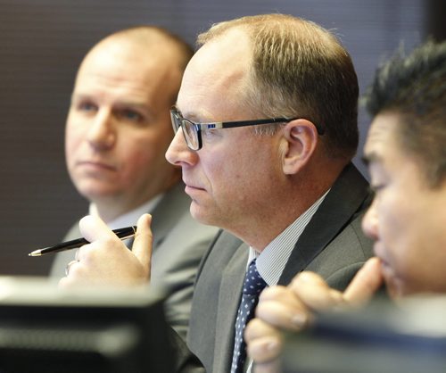 Councillor  Scott Gillingham, centre, in his first finance committee meeting at City Hall Thursday with right Deputy Mayor Mike Pagtakhan and Sherwood Armbruster, City Clerk's Department. Aldo Santin story Wayne Glowacki / Winnipeg Free Press Nov. 20  2014