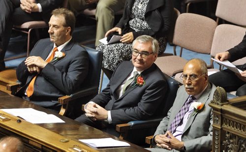 Stan Struthers (Dauphin) a member of the NDP rebel gang of five sits in his new seat flanked by Ron Kostyshyn (Swan River) (left) and Mohinder Saran (The Maples) in the Manitoba Legislative Assembly Chamber for the throne speech. 141120 November 20, 2014 Mike Deal / Winnipeg Free Press