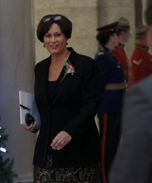 Theresa Oswald wearing an orange carnation comes out of the house after the Throne Speech at beginning of the    4th Session of 40th Manitoba legislature Throne Speech for the opening  fall session of the legislature . NOV. 20 2014 /KEN GIGLIOTTI / WINNIPEG FREE PRESS