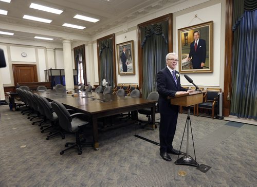 with portraits of Gary Doer and Gary Filmon , Greg Selinger talks to media after  4th Session of 40th Manitoba legislature Throne Speech for the opening  fall session of the legislature . NOV. 20 2014 /KEN GIGLIOTTI / WINNIPEG FREE PRESS