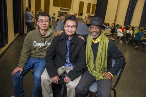 141120 Winnipeg - DAVID LIPNOWSKI / WINNIPEG FREE PRESS  (L-R) Sunny Min, Slone, Phan (both from Burma), and Evasio Murenzi (from Rwanda) are all extras in final scene of Fidelio, as well as former refugees. They pose for a photo  Thursday evening during a break from a dress rehearsal at the Centennial Concert Hall.