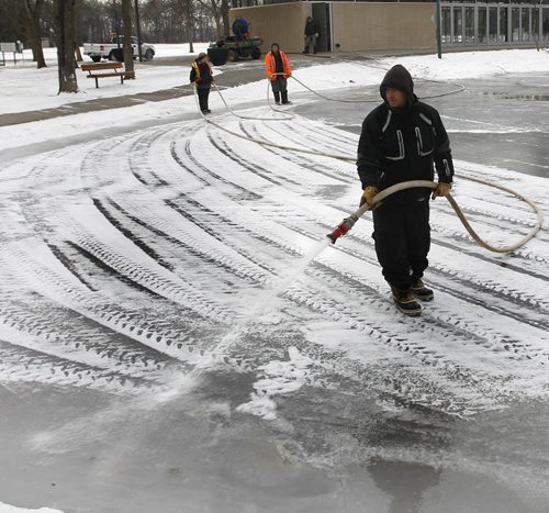 Ernie Bondarchuk, with the City Of Winnipeg, Public Works dept. floods the Duck Pond in St. Vital Park Friday morning. Weather permitting outdoor skating could commence in a week.    Wayne Glowacki/Winnipeg Free Press Nov.21 2014