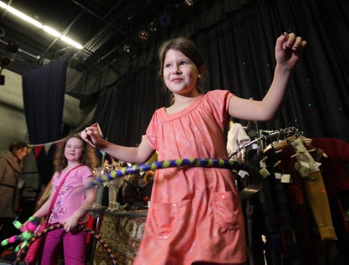 Nine-year-old Nilaya Komus tries out a handcrafted hoola hoop by Kazual Art & Sol while attending The 11th annual Holidaze Craft Show Saturday at the West End Cultural Centre. The event which continues on Sunday from 10am  - 7 pm. features fine, funky and local gifts by Manitoba artisans. Admission is free.   Standup photo. Nov 22,  2014 Ruth Bonneville / Winnipeg Free Press
