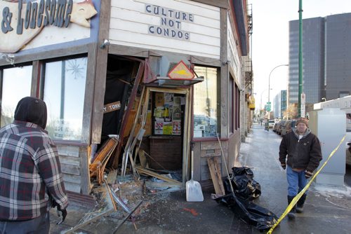 LOCAL - SUV crashes into doors in Winnipeg nightclub Times Change(d). The crash happened at around 9:15 a.m. at the corner of Main Street and St. Mary Avenue. John Scoles, right, is the owner and is scene in front of his business. BORIS MINKEVICH / WINNIPEG FREE PRESS November 24, 2014