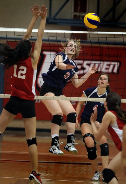 St Mary's Flame #9 Lindsay Solumdson knocks one through the MBCI defence Monday evening at U of W during the MHSAA "AAAA" Volleyball Championship games. St Mary's Acadamy went on to win the title. November 24, 2014 - (Phil Hossack / Winnipeg Free Press)